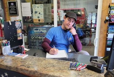 DJ Gibson on the phone at the front counter